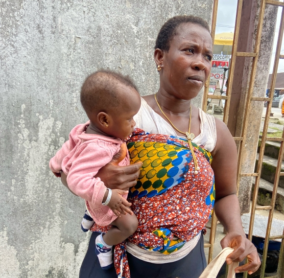 Akpesiri Ojiko with her daughter who was detained in the hospital because the family could not pay her medical bill. 