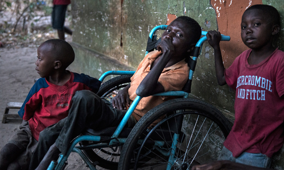 Etienne Tshiluanji (28, in wheelchair); Kudiva Mayele (9 yrs old) and Jonathan Mayele (7 years).