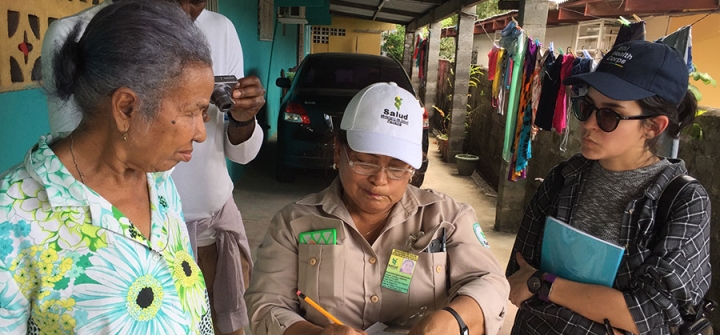 An IBM Health Corps team member (right) evaluating the manual data collection process of a Panama Health Department field worker as she interacts with citizens. 
