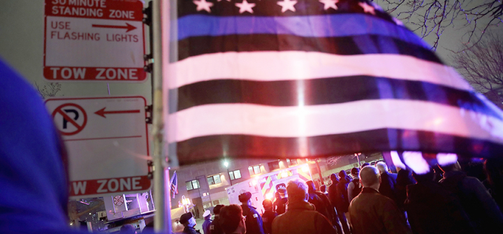 Police and firefighters following an ambulance after Chicago Police officer Samuel Jimenez was killed.