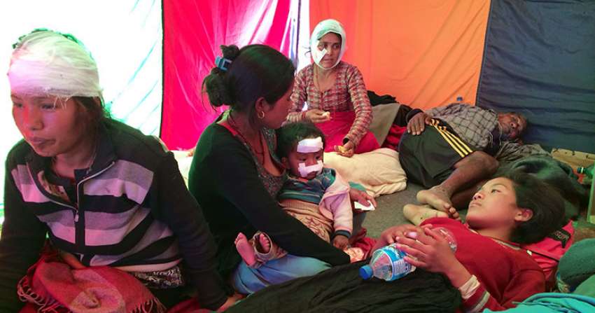 People injured by the earthquake—and now homeless—in a tent in Sindhupalchowk, receiving medical care.