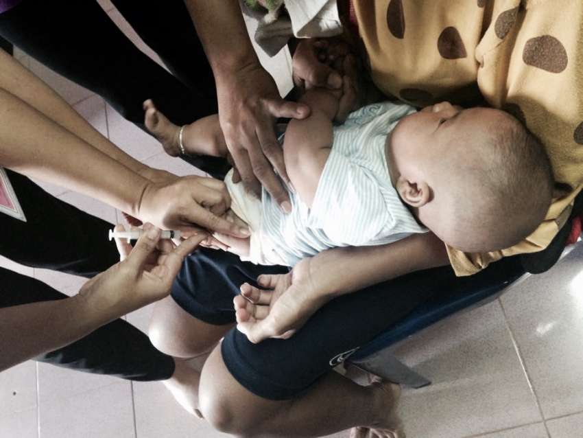 child in thailand receiving vaccine