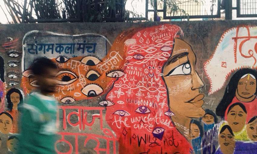 Women painted a wall with eyes that stare back, and the message “We won’t be intimidated by your gaze."