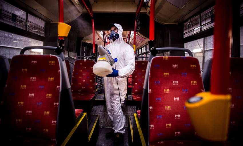 A worker in Bratislava disinfects the interior of a public bus. Image: Vladimir Simicek/AFP via Getty Images