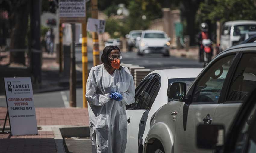 A health worker conducts drive-through novel coronavirus testing in Johannesburg yesterday. Photo: Marco Longari/AFP via Getty Images
