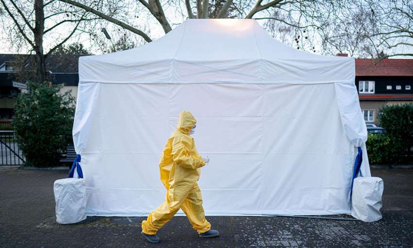 Paramedic Nina Leimer passes a COVID-19 testing tent in Berlin, Germany, March 30, 2020. Image: Kay Nietfeld/Picture Alliance/Getty