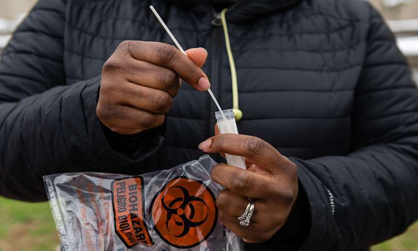 A resident inserts a nasal swab into a test tube while in line at a Covid-19 testing site run by the Centers for Disease Control (CDC), Federal Emergency Management Agency (FEMA) and eTrueNorth in Washington, D.C., U.S., on Wednesday, Jan. 5, 2022. The U.S. recorded over a million coronavirus cases on Monday, nearly doubling the previous records with hospitalizations increasing fueled by the virus rapidly spreading among the unvaccinated. Photographer: Eric Lee/Bloomberg via Getty Images