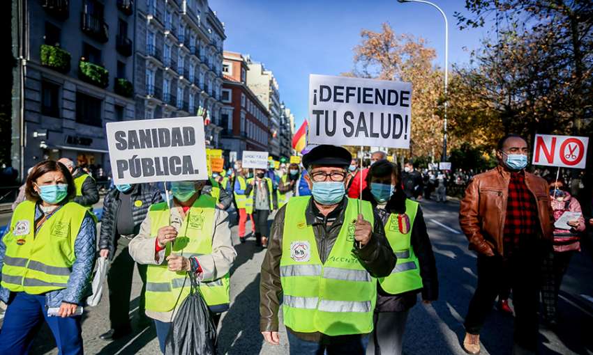 A man holds a banner reading "Defend your health!", in a demonstration in defense of primary care, on 12 December, 2021 in Madrid, Spain. 