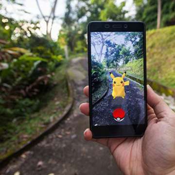 iphone with pokemon on a nature path