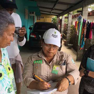 An IBM Health Corps team member (right) evaluating the manual data collection process of a Panama Health Department field worker as she interacts with citizens. 