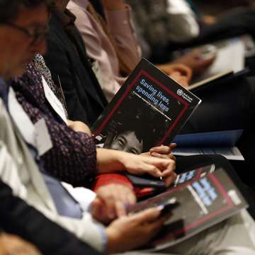 Audience members peruse a new WHO report on NCDs at its May 20 release in Geneva. (Image: Courtesy of Bloomberg Philanthropies)
