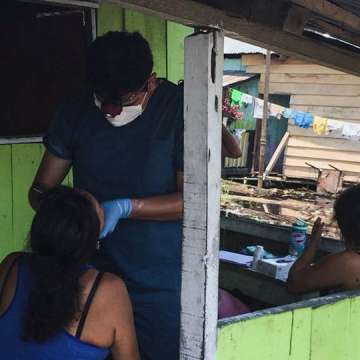 Marco Alarcon, DDS, MS, conducts an oral examination in Peru's impoverished Claverito settlement. 