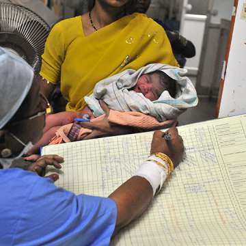 A nurse registers the records of a new born baby boy at Governement Gandhi Hospital in Hyderabad on October 31, 2011.