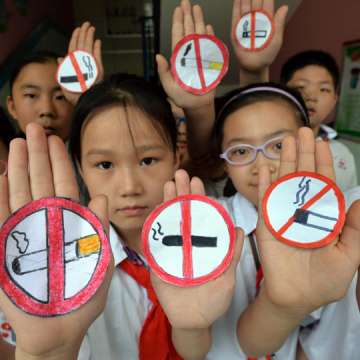Students hold up no smoking signs to support World No Tobacco Day at a primary school in northern China's Hebei province, on May 30, 2016. STR/AFP/Getty Images