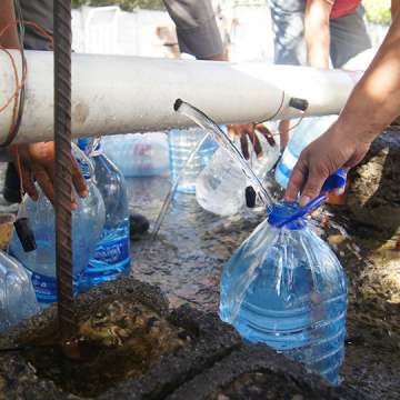 Cape Town residents fill their water jugs at the Highlands Spring in February 2018.