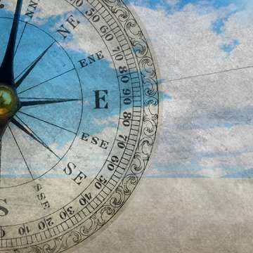 Graphic composition of a compass over sky
