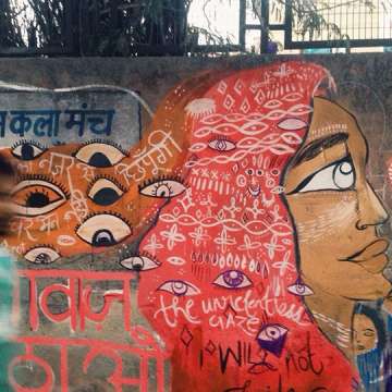 Women painted a wall with eyes that stare back, and the message “We won’t be intimidated by your gaze."