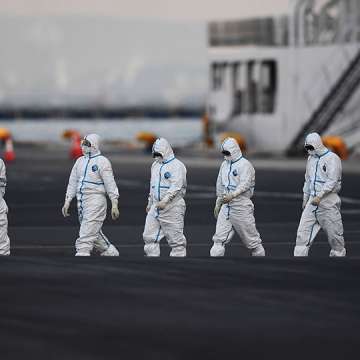 People wearing protective suits walk from the Diamond Princess cruise ship, with around 3,600 people quarantined onboard due to fears of the new coronavirus, at the Daikoku Pier Cruise Terminal in Yokohama port, February 10, 2020. Image: Charly Triballeau/AFP/Getty