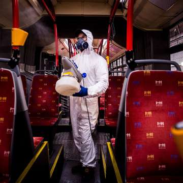 A worker in Bratislava disinfects the interior of a public bus. Image: Vladimir Simicek/AFP via Getty Images