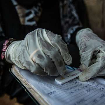 Habiba Suleiman, 29, a district malaria surveillance officer, records the results of a rapid diagnostic test for malaria at a home visit in Zanzibar, January 28, 2015. 