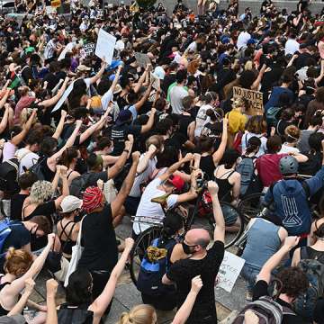 Protesters raise fists during a Black Lives Matter demonstration in Brooklyn, New York on June 5, 2020. Image: Angela Weiss/AFP/Getty