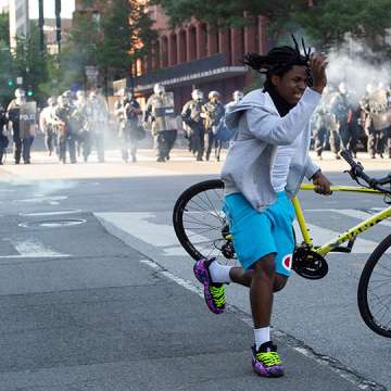 A protester flees as police use tear gas and rubber bullets to disperse a crowd near the White House, June 1, 2020. Image: Roberto Schmidt/AFP/Getty