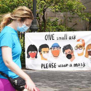 A person walks by a sign that reads "One small ask, please wear a mask." New York City, May 27, 2020.   Image: Rob Kim/Getty