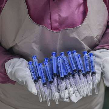 A worker displays syringes at the Hindustan Syringes factory in Faridabad as India ramped up production ahead of a coronavirus vaccine rollout. September 2, 2020 Image: Sajjad Hussain/AFP/Getty