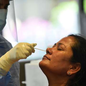 A Nepalese health worker takes a nasal swab of a parliamentary lawmaker for a coronavirus PCR test in  Kathmandu on May 5. Image: Narayan Maharjan/NurPhoto via Getty