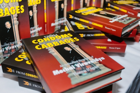 Close-up of copies of the book From Condoms to Cabbages, Thomas D'Agnes's biography of Mechai Viravaidya