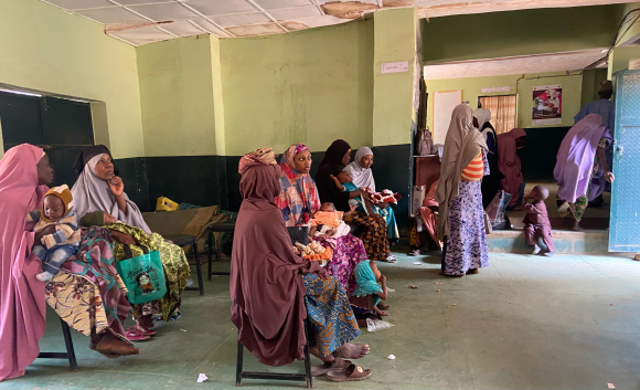 Women wait with their children to be vaccinated in the Farfaru primary clinic.